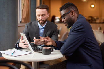 Two businessmen having a look at the laptop screen.