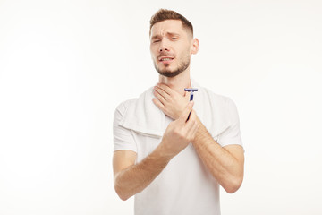 Man shaving his facial hair off carefully.