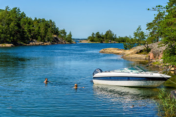 Two boys taking a swim in the beautiful St Anna's archipelago in the Baltic Sea on a sunny and warm...