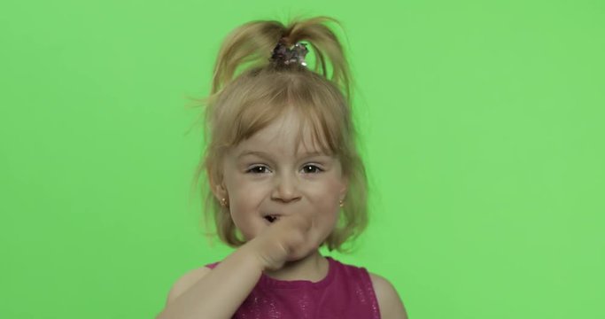 Child portrait in purple dress. Hides her face with hands and sculps. Chroma Key