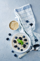 Oatmeal porridge with fresh blueberries and blackberries