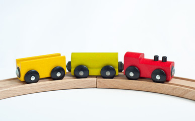 Wooden toy train with colorful blocks on a wooden railway. Educational toys.