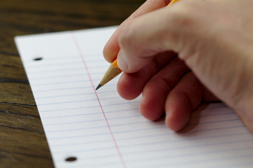 Pencil writing on paper close up back to school ready to write and take notes