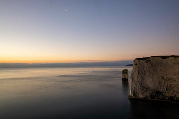Fototapeta na wymiar Early sunrise at white cliffs of Jurassic Coast in South of England near Swanage