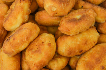dish with homemade pies cooked fried in a pan ruddy appetizing close-up
