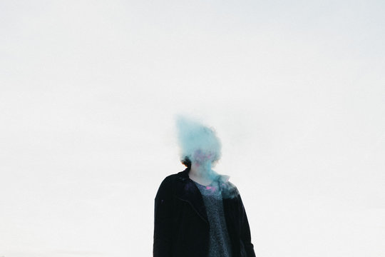 Girl with blue smoke around her face