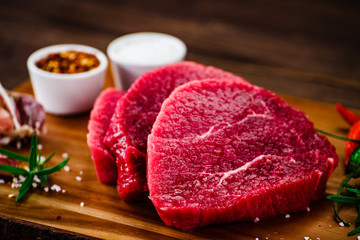 Fresh raw beef steaks on cutting board