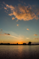 Cloud highlighted by the sun over the water at sunset