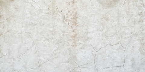 Old gray wall with cracks on the plaster. Abstract background