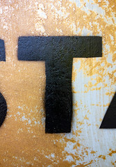 Written Wording in Distressed State Typography Found Letter T