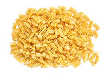 Dried corkscrew shaped pasta or fusilli pasta over white background