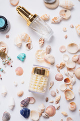 Fototapeta na wymiar precious skin care cosmetics around natural shells and gemstones. close up