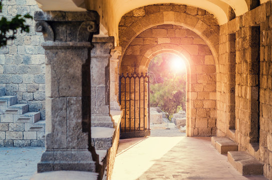 A romantic Medieval room. Beautiful sun light coming through an arch way of a medieval castle of Hospitallers in  Rhodes, Greece. 