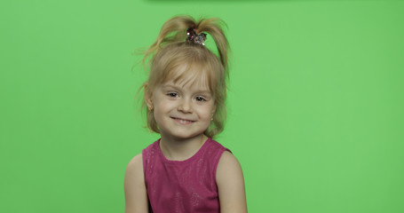 Positive girl looking to a camera in purple dress. Happy child. Chroma Key