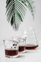 Transparent glass teapot and glasses on white background