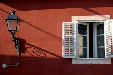 Fototapeta na wymiar Retro lantern and traditional Mediterranean window on a colorful facade. 