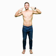 Fototapeta premium Handsome shirtless man showing nude chest smiling confident showing and pointing with fingers teeth and mouth. Health concept.