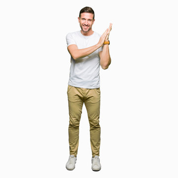 Handsome man wearing casual white t-shirt Clapping and applauding happy and joyful, smiling proud hands together