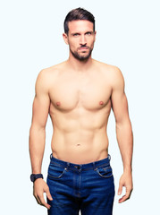 Fototapeta premium Handsome shirtless man showing nude chest skeptic and nervous, frowning upset because of problem. Negative person.