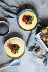 Sweet cornmeal porridge, topped with poppy seeds and currant