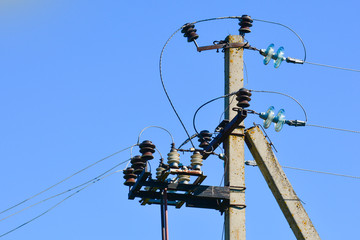 Pillar of electricity transmission line with transparent insulators. Photographed close-up. Against...