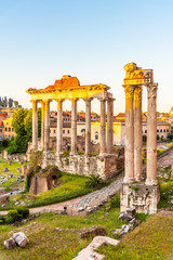 Fototapeta premium Roman Forum with ruins of Temple of Saturn on sunny summer morning. Antique ruins in Rome, Italy