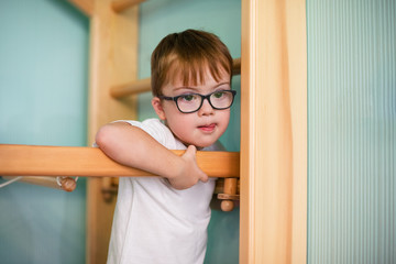 Boy with down syndrome playing at home