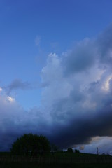 Obraz na płótnie Canvas Countryside, green heels and pond before thunderstorm