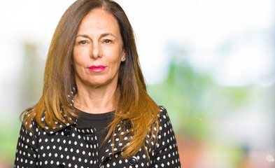 Beautiful middle age woman wearing fashion jacket Relaxed with serious expression on face. Simple and natural looking at the camera.