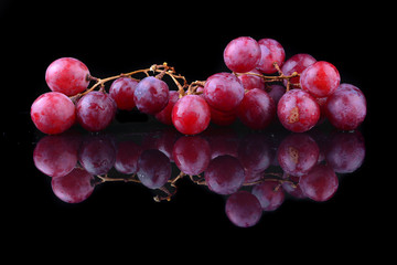 bunch of red grapes isolated on black background
