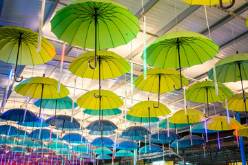 Multiple Colorful Umbrellas Hanging From The Roof