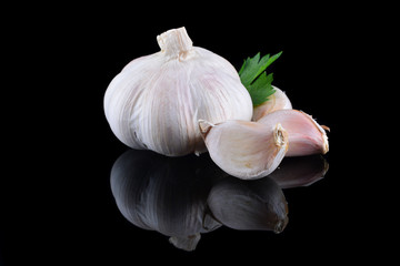 Garlic with reflection on black background
