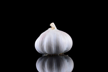Garlic with reflection on black background