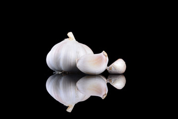Garlic with reflection on black background