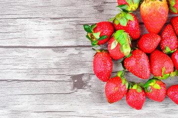 Strawberries over wooden background