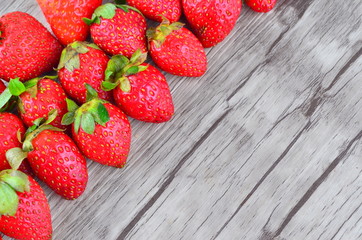Strawberries over wooden background