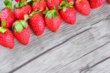 Strawberries over wooden background