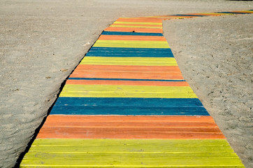 Colorful wooden walkway  to the beach .