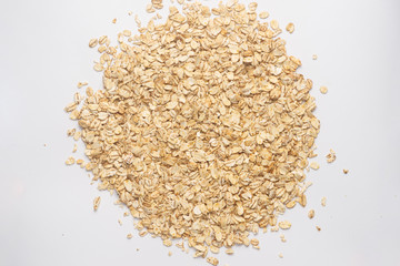 Cereal flakes for granola closeup. Flakes isolated on white background. Nutrition concept. Cereal flakes stock photo.