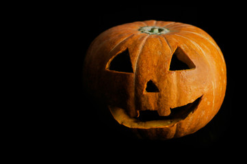 Jack o'lantern halloween pumpkin isolated on black background with copy space