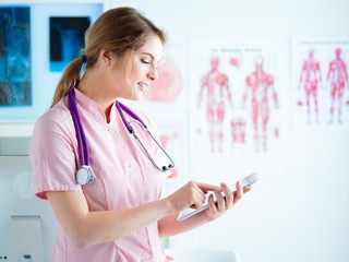 Doctor woman checking medical data on tablet pc