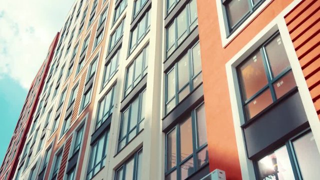 New apartments for sale. New modern architectural building house. Residential building on sky background. Exterior of new modern high-rise condominium apartments buildings with balconies and lodges