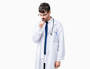 Young doctor man wearing hospital coat over isolated background feeling unwell and coughing as...