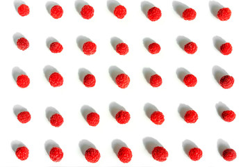 Colorful pattern of raspberries on white background. Flat lay. Top view, pattern
