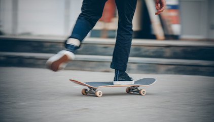 Skateboard man in shoes and jeans getting ready to jump kickflip olli from steps. Blurred background in motion