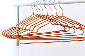 Empty metal cloth hangers on white background minimalism style. Empty hangers in a fashion store.