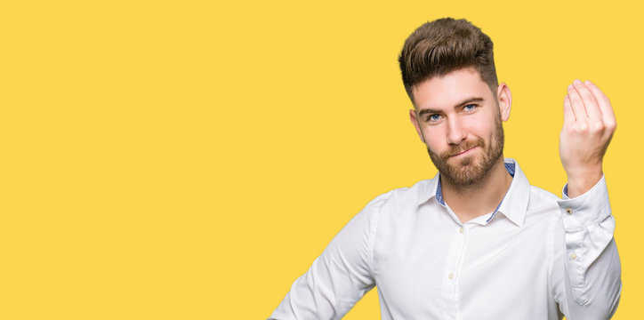 Young handsome business man Doing Italian gesture with hand and fingers confident expression
