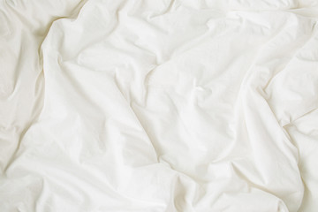 White bedding sheets. Cozy background. Flat lay, top view