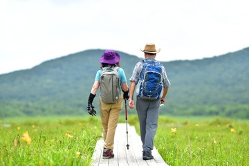 初夏の高原を歩くカップル