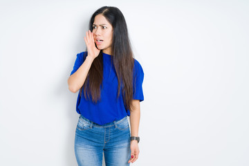 Fototapeta premium Beautiful brunette woman over isolated background shouting and screaming loud to side with hand on mouth. Communication concept.